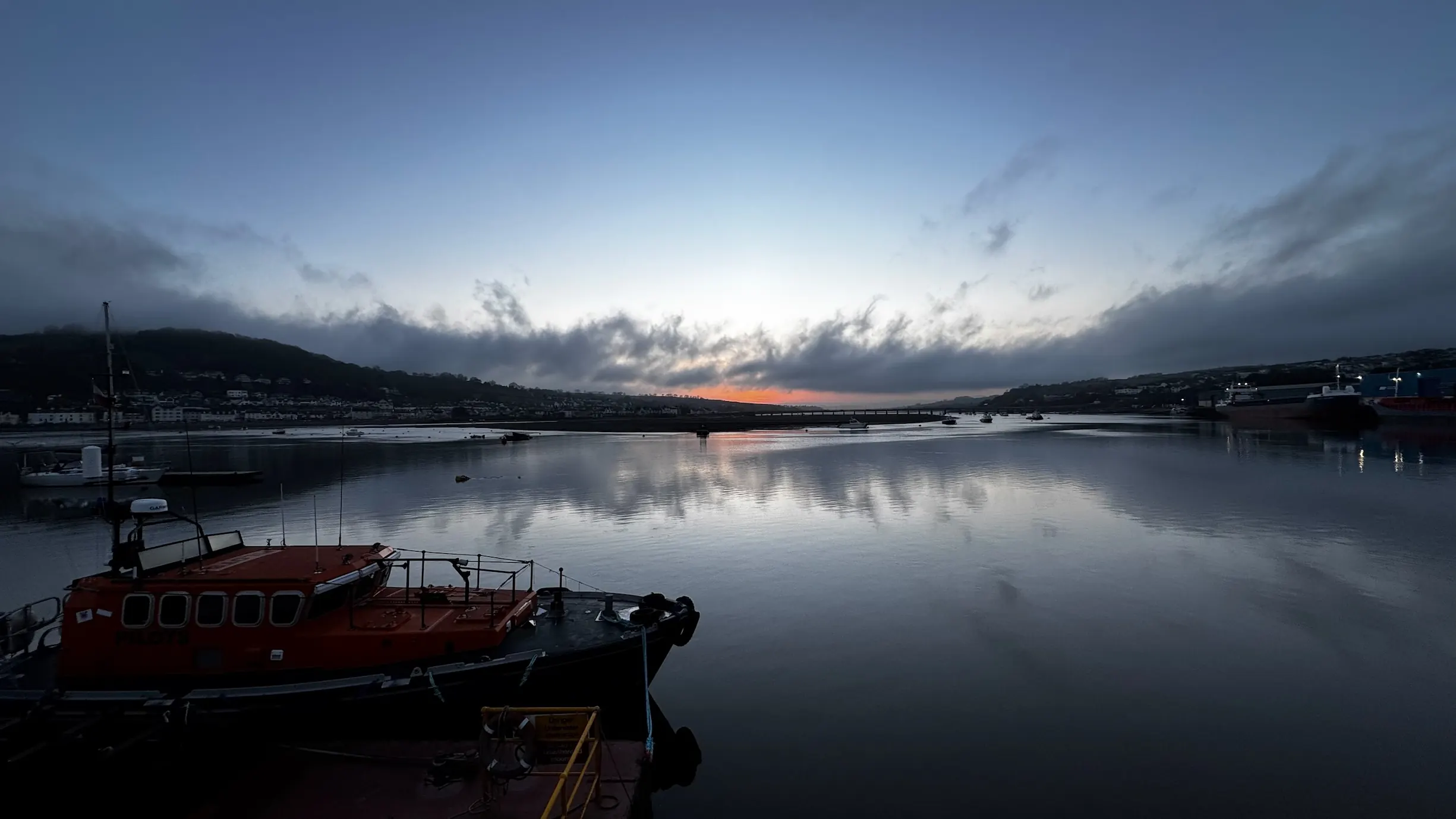 Past sunset picture of Teignmouth back beach and docks.