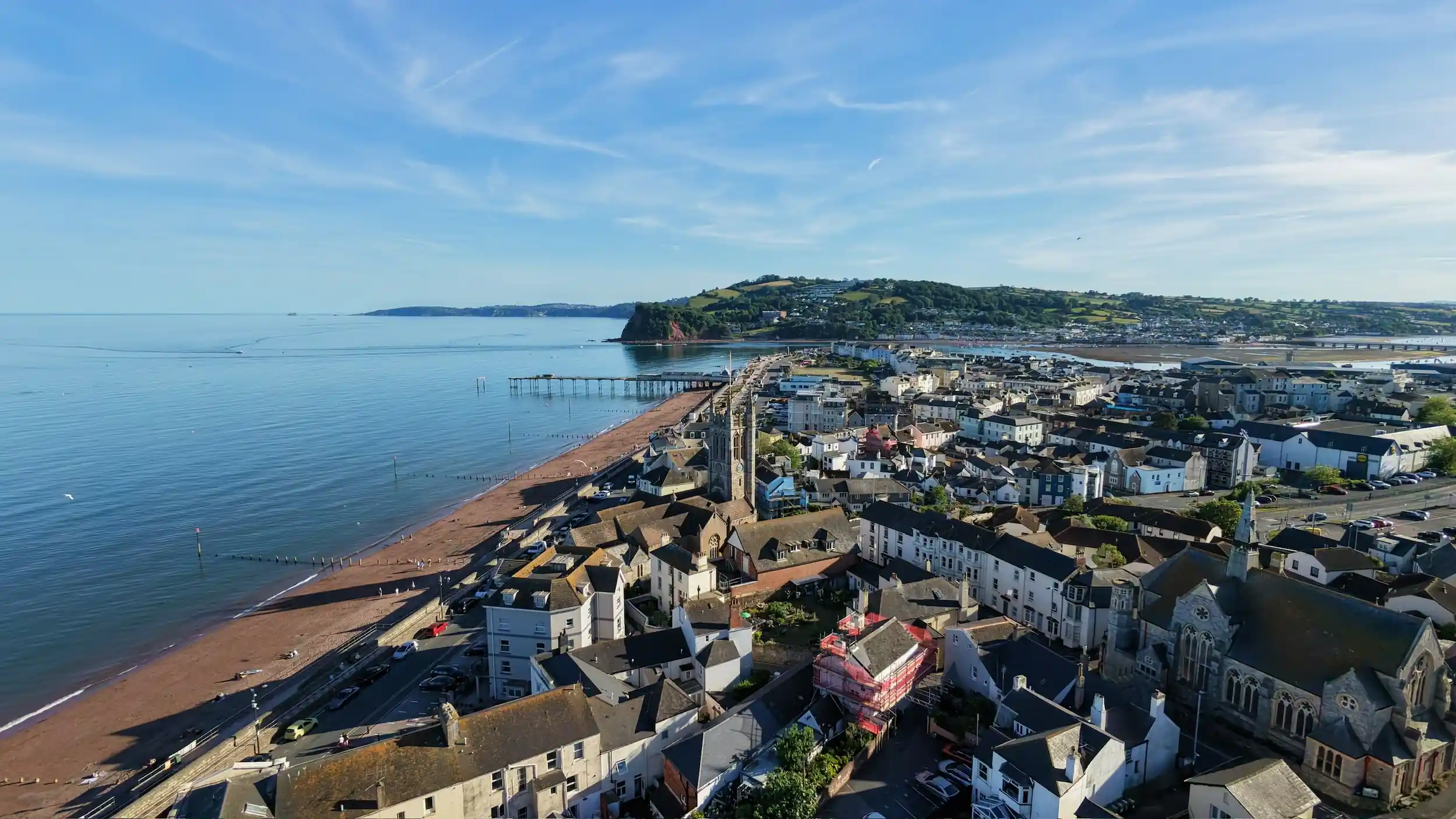 Ariel view of east Teignmouth, overlooking St Michaels Church and The Ness, Shaldon in the distance.