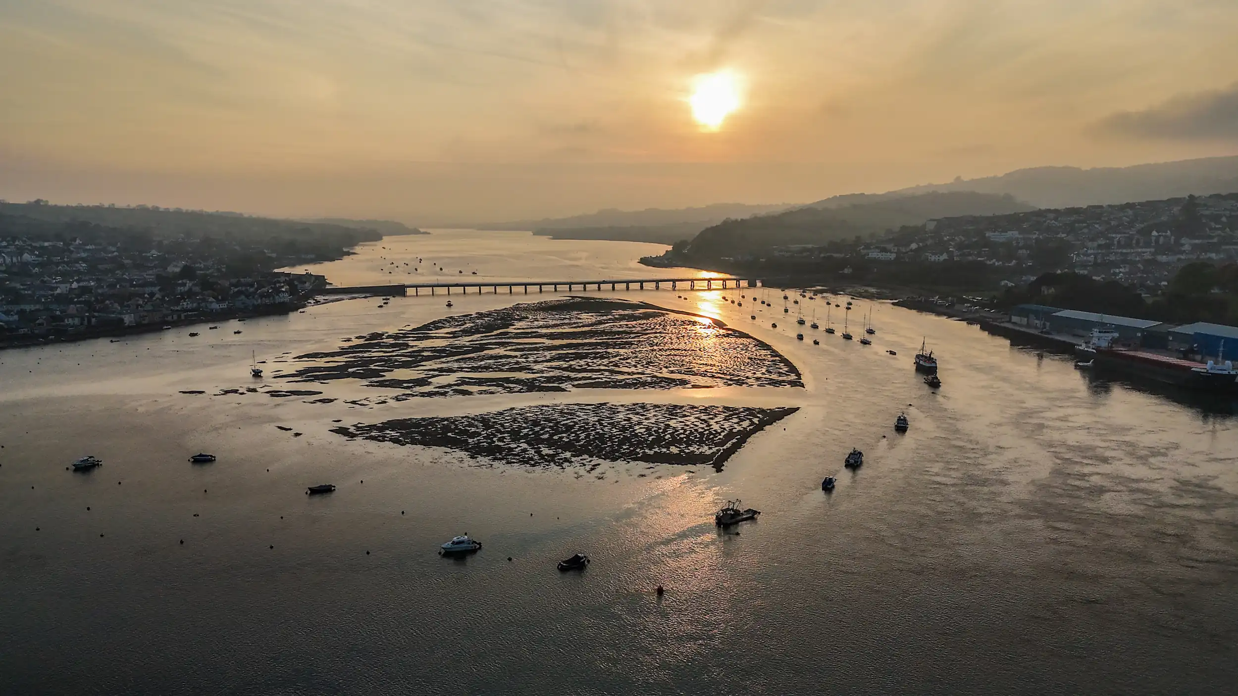 Slightly misty drone photo of down the River Estuary at sunset.