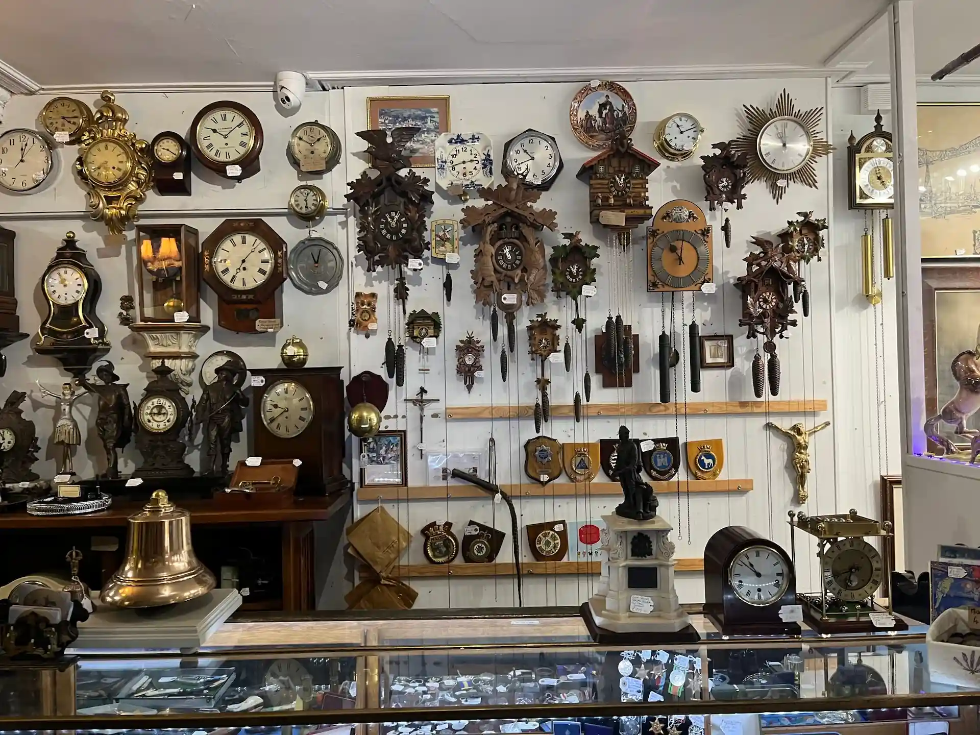 Inside Time Flies shop, facing a wall of antique clocks.